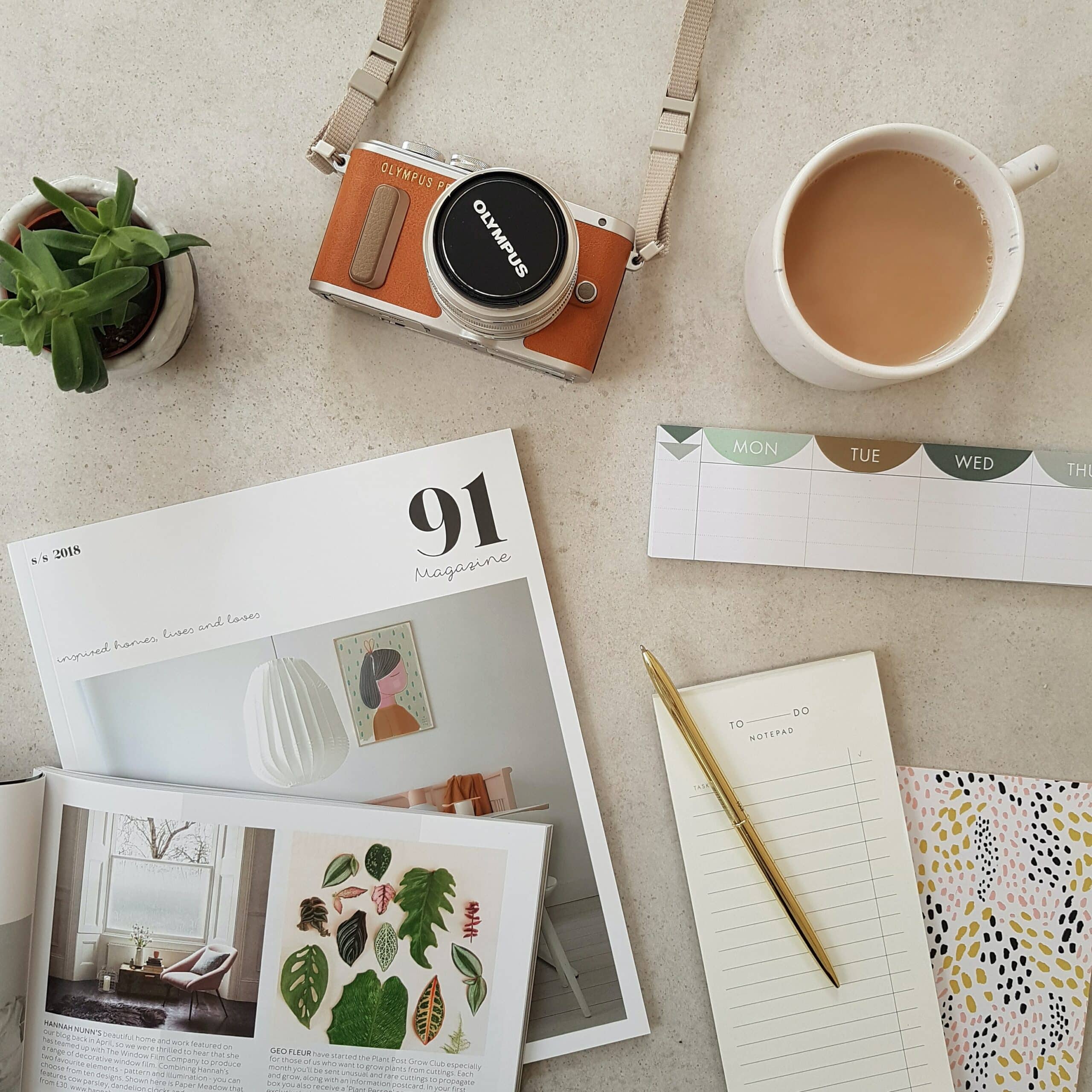 camera and note pads on a coffee table